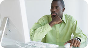 A man using a computer in a business setting.