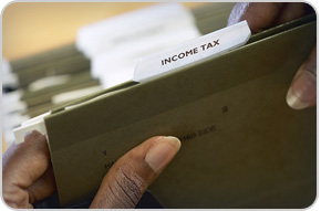 Photo of a husband and wife filling out their tax forms. Photo credit Library of Congress