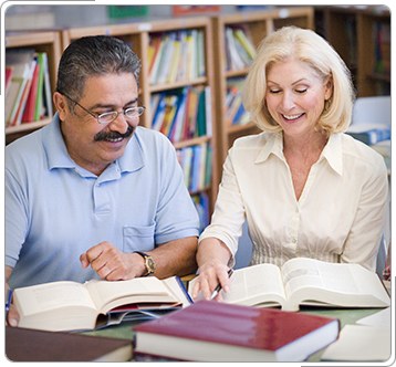 Two people studying in university library