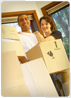 Military couple packing moving boxes.